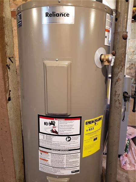 utility room featuring water heater