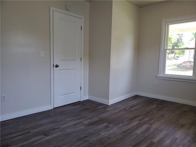 unfurnished room with dark hardwood / wood-style floors