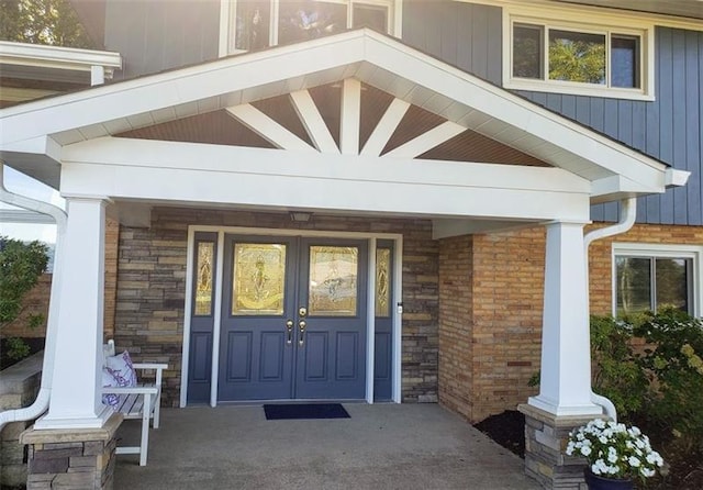 view of exterior entry featuring covered porch