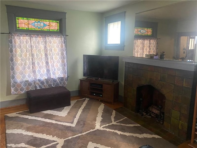 living room with dark hardwood / wood-style flooring and a fireplace