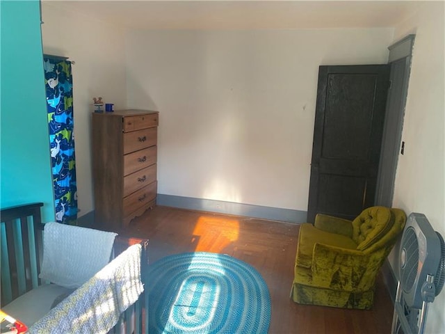 bedroom with dark wood-type flooring