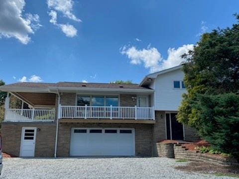 view of front of home with a balcony and a garage