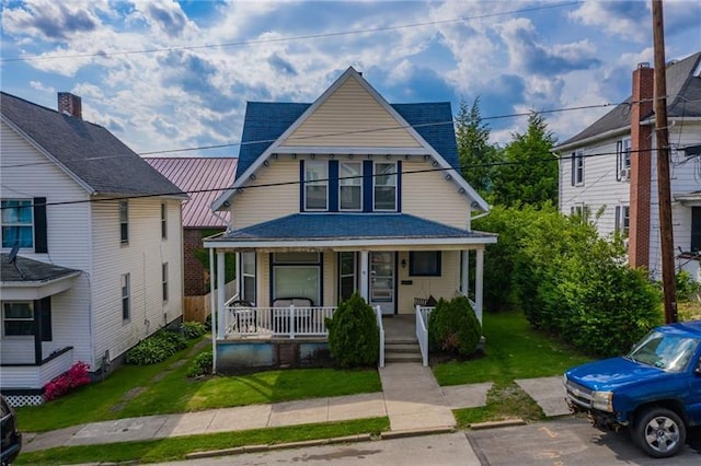 view of front of house featuring a porch and a front yard