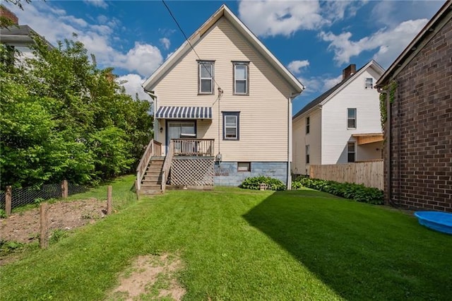 back of house featuring a lawn