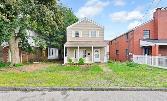 front of property with a front yard and covered porch