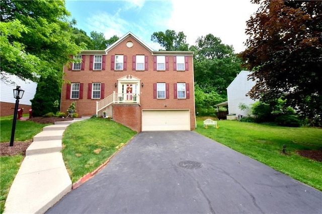 view of front of house with a front yard and a garage