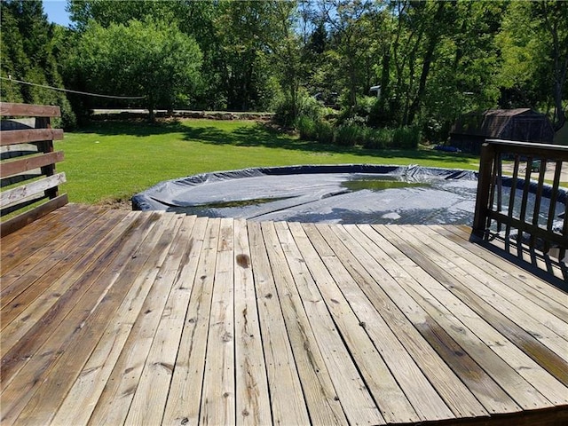 wooden terrace featuring a lawn