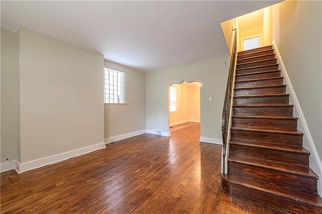 stairs featuring dark wood-type flooring