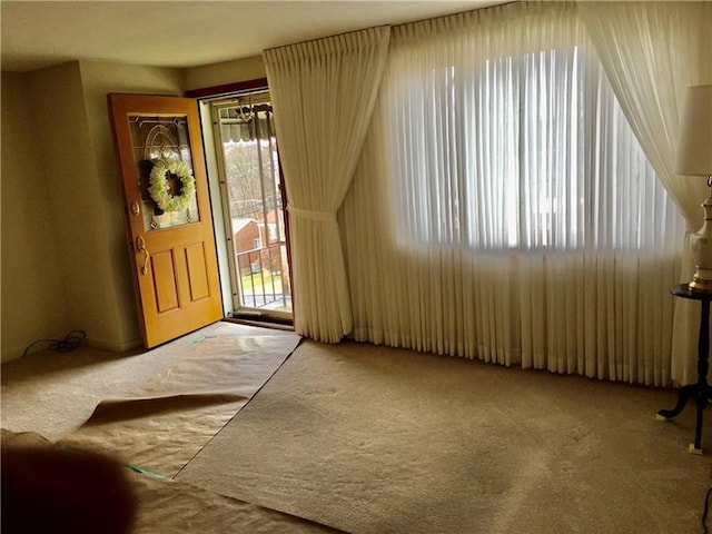 entryway with light colored carpet