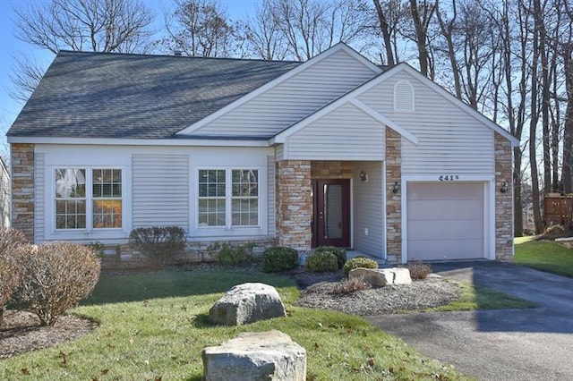 view of front facade with a front yard and a garage