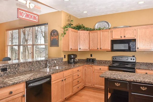 kitchen with black appliances, sink, light wood-type flooring, dark stone countertops, and light brown cabinetry