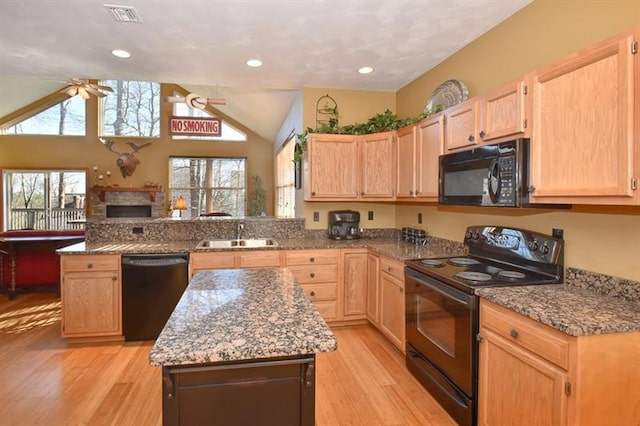 kitchen with lofted ceiling, ceiling fan, light wood-type flooring, and black appliances