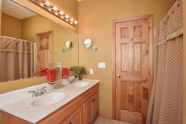 bathroom with dual vanity and tile floors