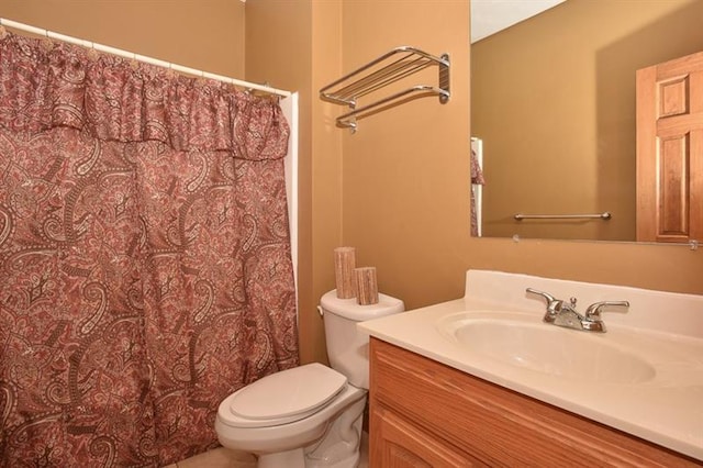 bathroom featuring toilet and vanity