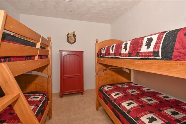 carpeted bedroom featuring a textured ceiling