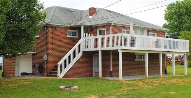 back of house with a lawn and a fire pit