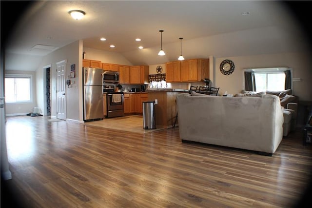 living room featuring vaulted ceiling and hardwood / wood-style flooring