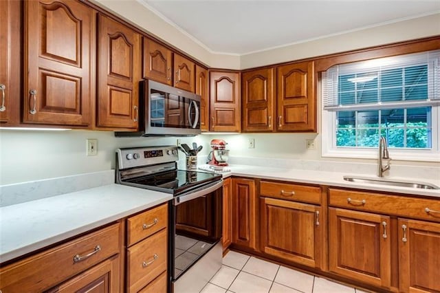 kitchen featuring ornamental molding, stainless steel appliances, light tile floors, and sink