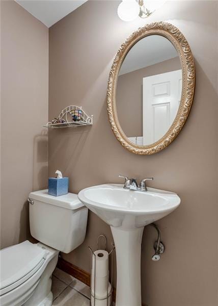 bathroom with toilet and tile floors