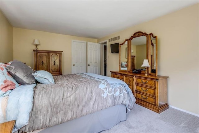 bedroom with light colored carpet