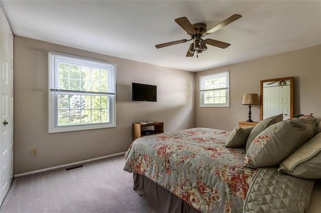 bedroom with light carpet and ceiling fan