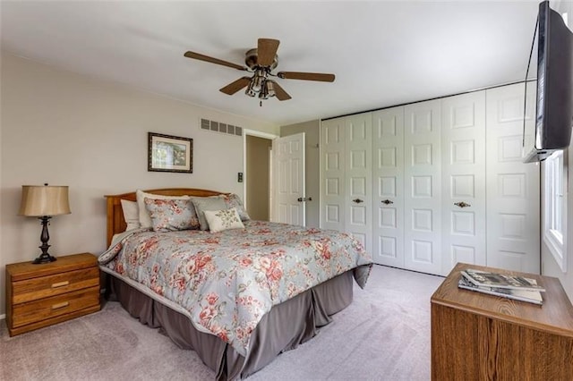 bedroom featuring light carpet and ceiling fan