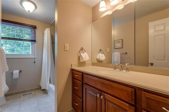 bathroom featuring tile floors, vanity, and shower / tub combo with curtain