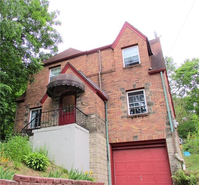 english style home with a garage