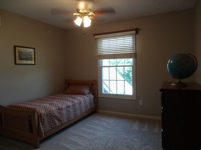 bedroom featuring ceiling fan and dark colored carpet