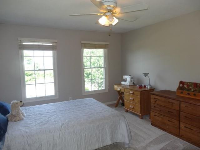 bedroom featuring light carpet and ceiling fan