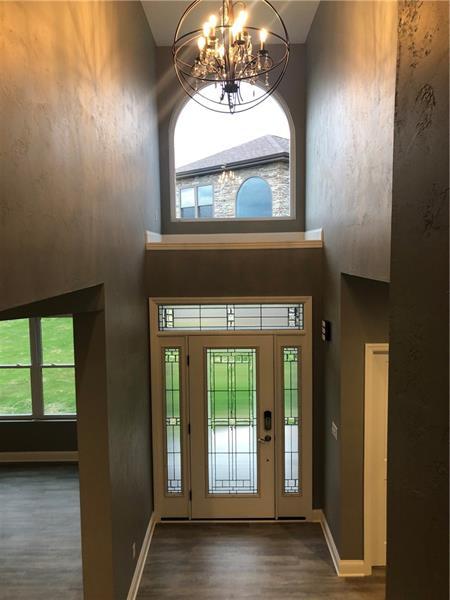 foyer entrance featuring a chandelier and dark wood-type flooring