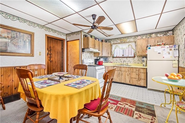 dining area with a drop ceiling, sink, ceiling fan, and light tile floors