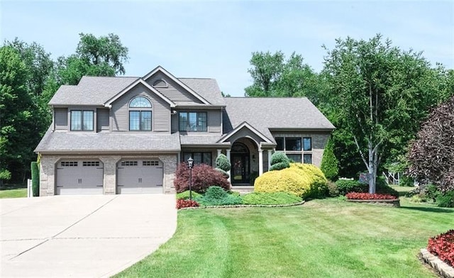 view of front of property with a front yard and a garage