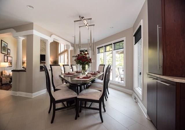 dining space featuring decorative columns