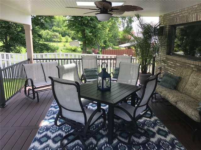 wooden deck featuring ceiling fan