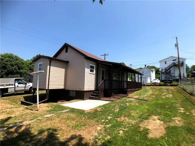 rear view of property featuring a lawn