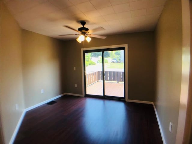 empty room featuring ceiling fan and dark hardwood / wood-style flooring