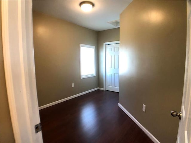 spare room with dark hardwood / wood-style flooring