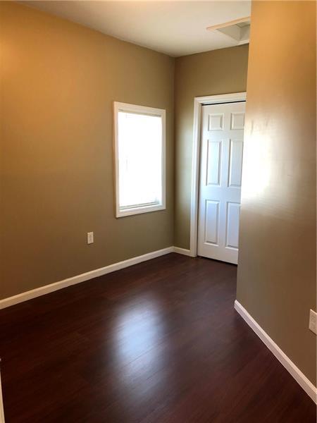 unfurnished bedroom with dark hardwood / wood-style floors