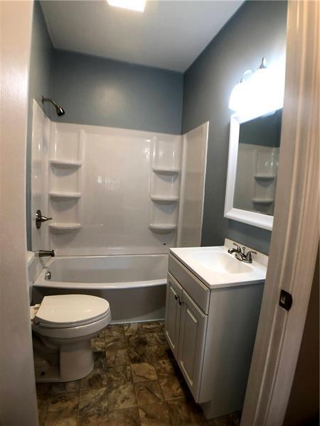 full bathroom featuring toilet, washtub / shower combination, tile flooring, and vanity