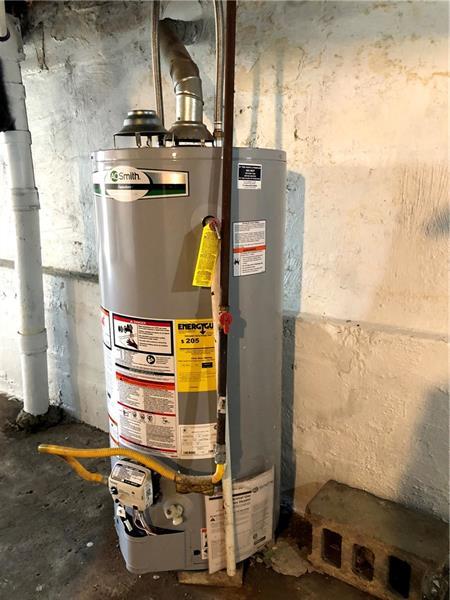 utility room with gas water heater