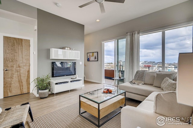 living room featuring ceiling fan and light wood-type flooring