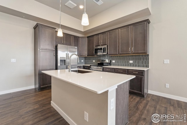 938 Schlagel St Unit 7, Fort Collins, CO 80524 - kitchen with decorative backsplash, dark wood-style flooring, stainless steel appliances, dark brown cabinetry, and a sink