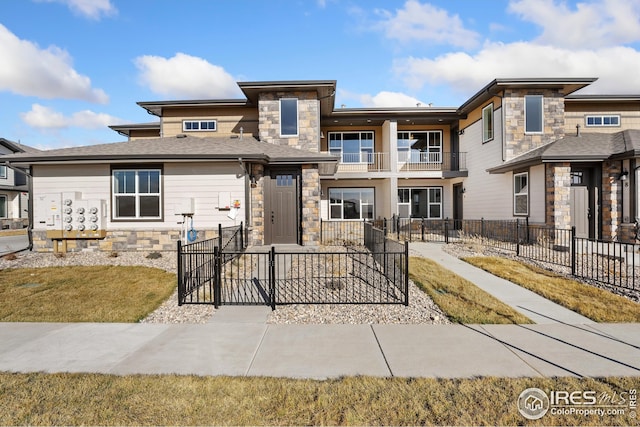 938 Schlagel St Unit 7, Fort Collins, CO 80524 - view of front of house with stone siding, fence, and a balcony