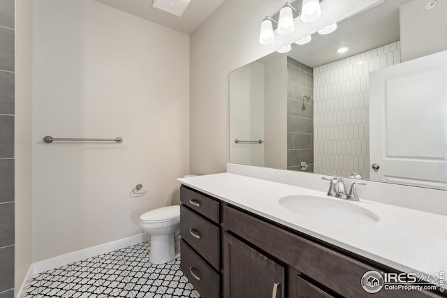 938 Schlagel St Unit 7, Fort Collins, CO 80524 - bathroom with baseboards, toilet, tiled shower, and vanity