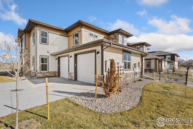 938 Schlagel St Unit 7, Fort Collins, CO 80524 - view of front of home featuring stone siding, driveway, a garage, and fence