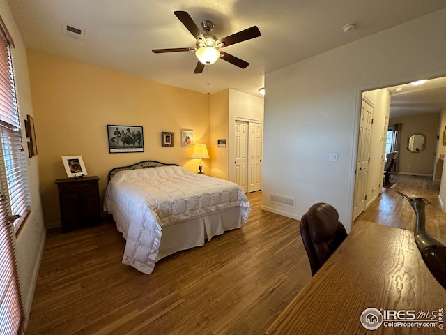 bedroom featuring a closet, visible vents, and wood finished floors