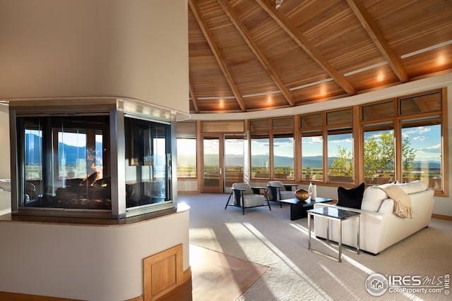 living room with high vaulted ceiling, carpet, a mountain view, wooden ceiling, and beamed ceiling