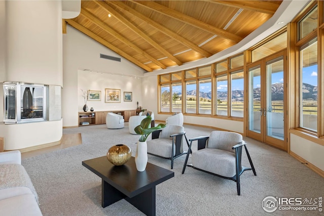 living room featuring beamed ceiling, a mountain view, wooden ceiling, and high vaulted ceiling