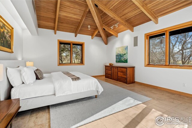 bedroom with multiple windows, vaulted ceiling with beams, and wood ceiling